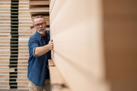 Man in front of woodpile 