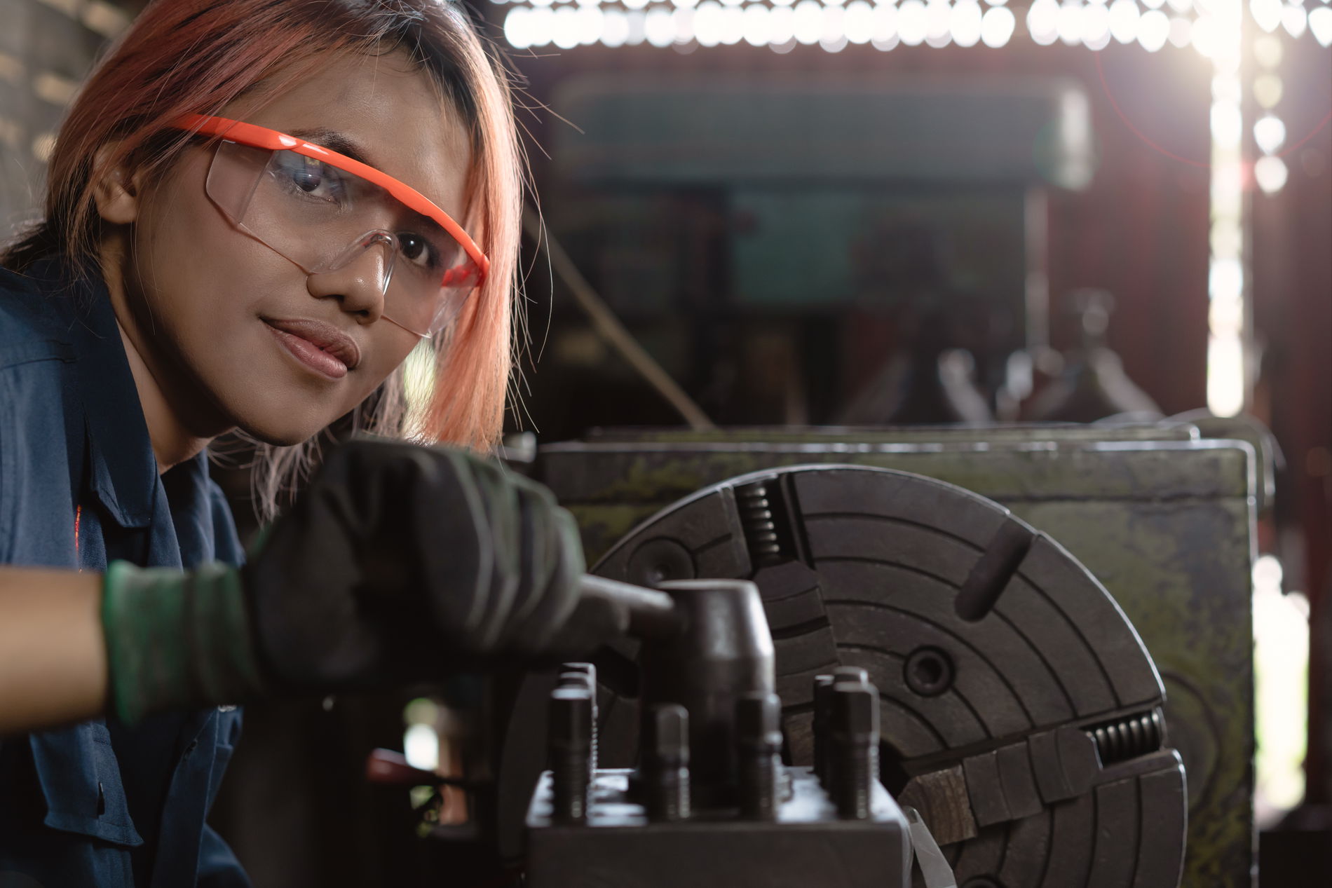 Girl at machine wearing safety goggles