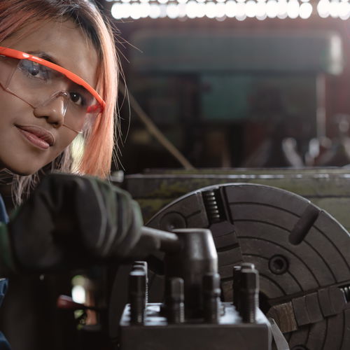 Girl at machine wearing safety goggles