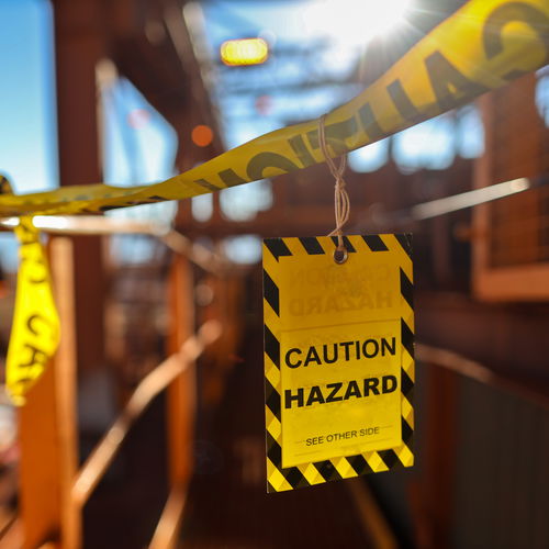 Caution Hazard sign on an industrial bridge