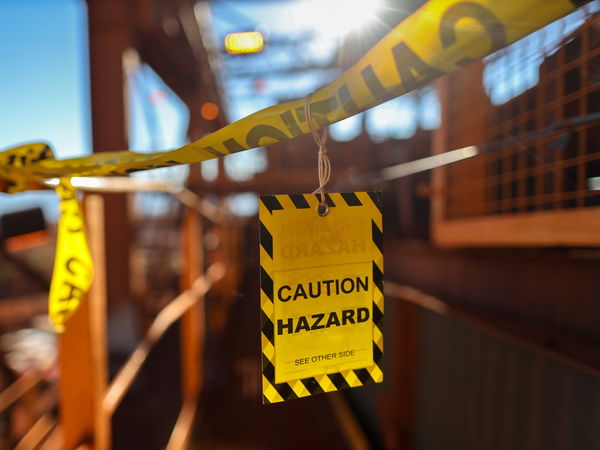 Caution Hazard sign on an industrial bridge