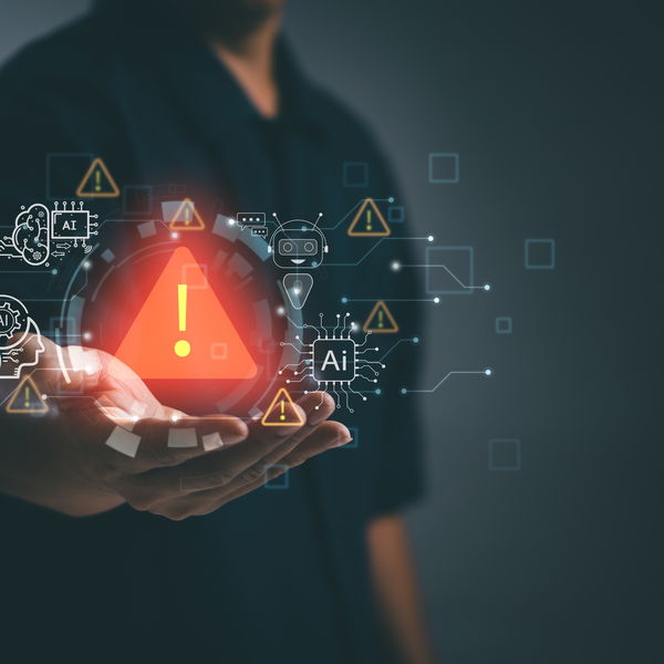 Man with outstretched hand holding illuminated holographic warning sign