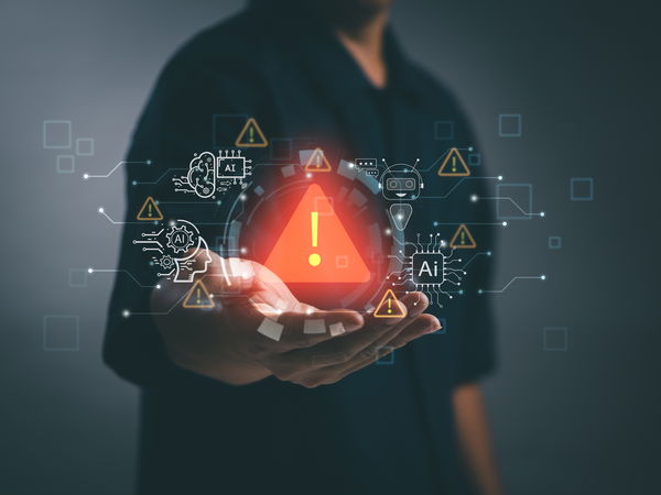 Man with outstretched hand holding illuminated holographic warning sign