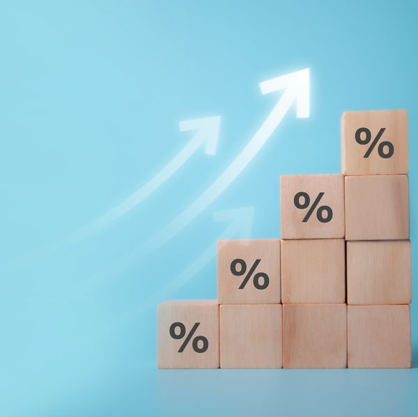 Wooden blocks with percent signs and arrows pointing upward