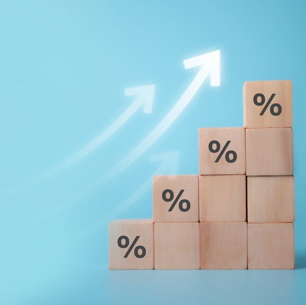 Wooden blocks with percent signs and arrows pointing upward