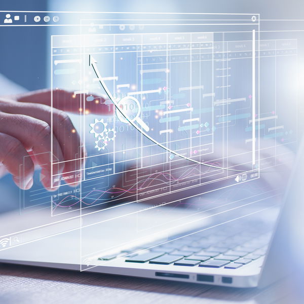finger in front of laptop points to holographic statistics