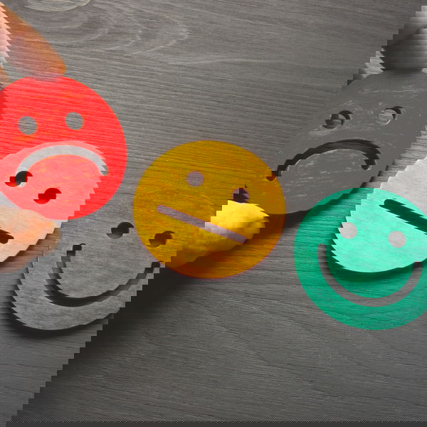 Three smileys. Laughing green, neutral yellow, sad red