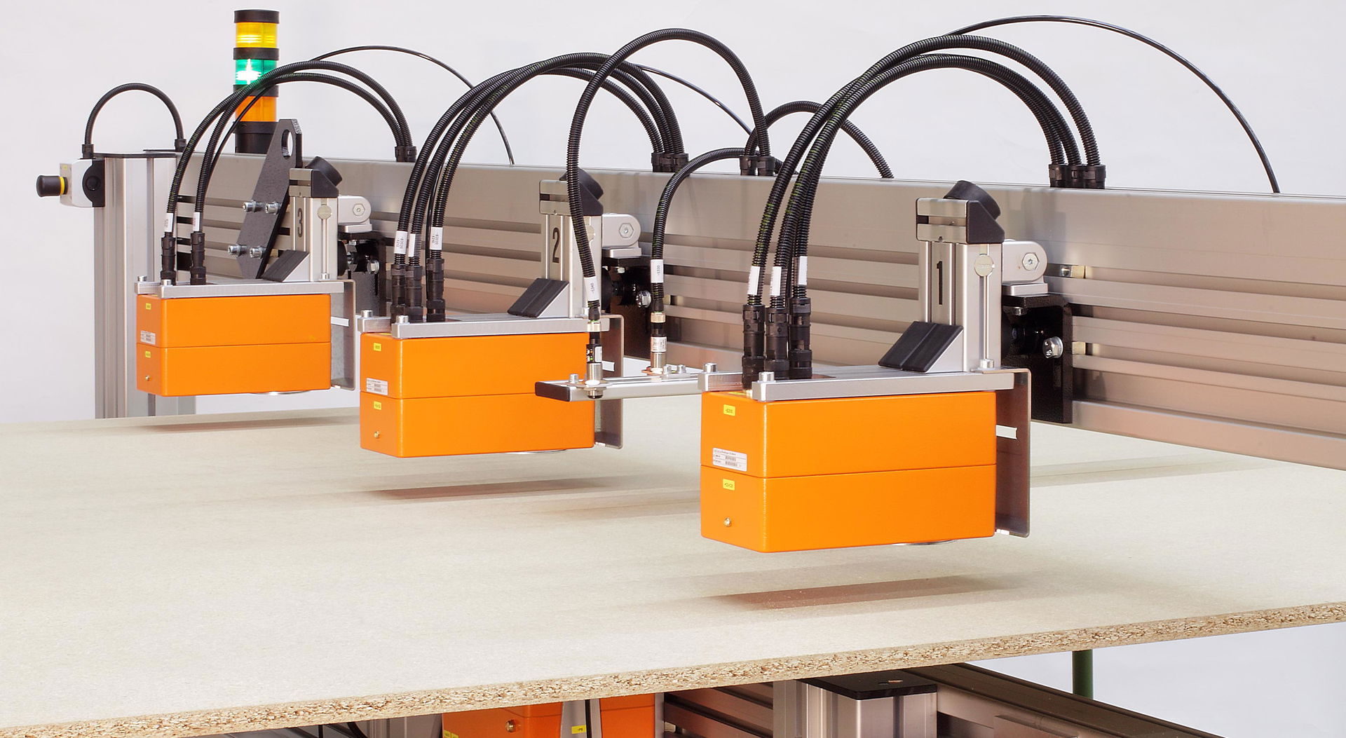 GreCon BOARDSCALE product as an orange X-ray scanner above the production line.