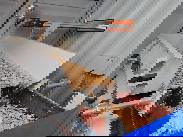 Wood chips running along a conveyor belt in a production facility.