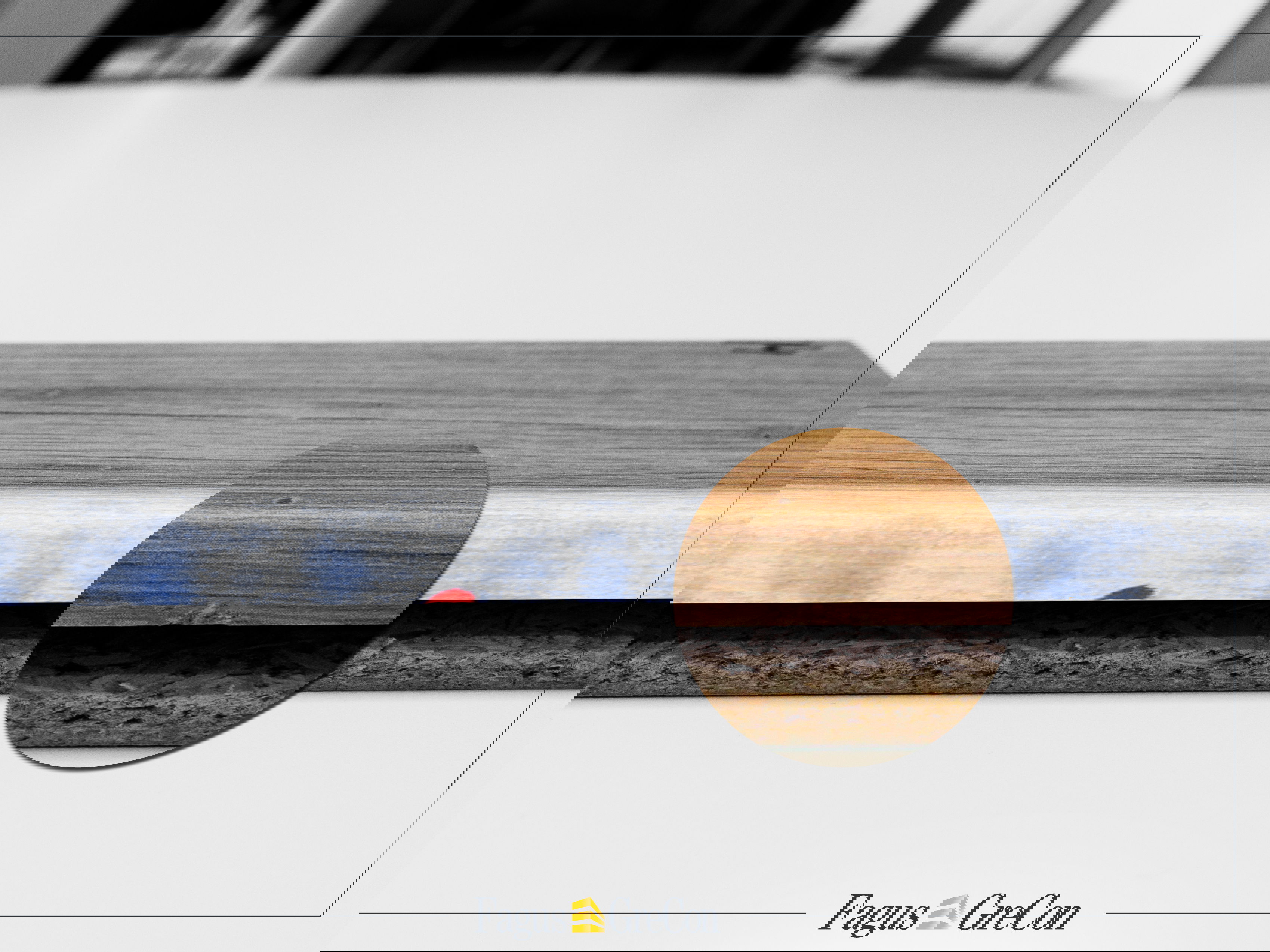 Minimal damage to a wooden board, highlighted in red and magnified with a magnifying glass