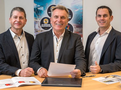 Three managing directors of Fagus-GreCon in front of a bar table.
