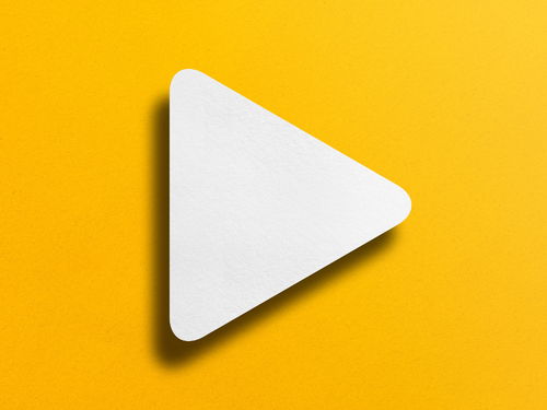 Video Play button on yellow wall